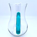 Transparent glass decanter and green handle