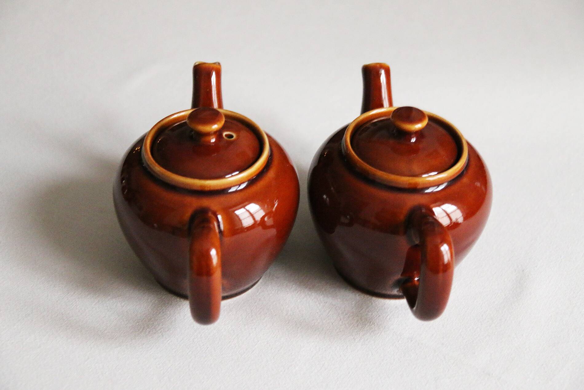 2 brown glazed ceramic teapots