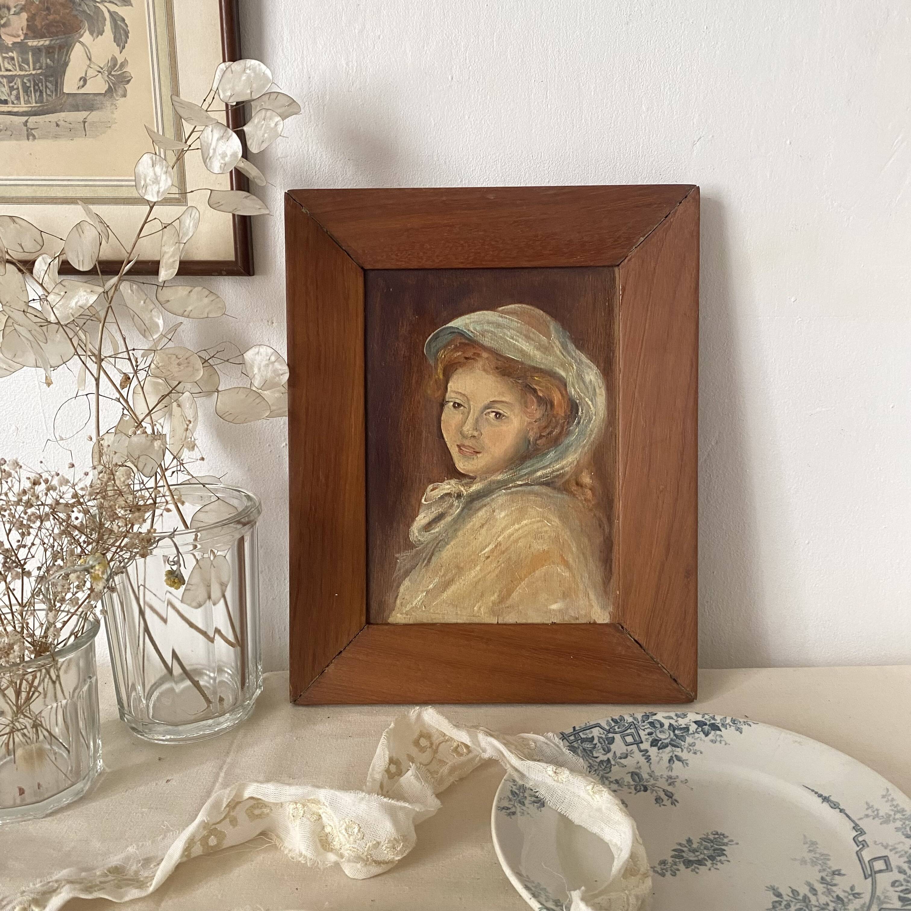 Old oil portrait on wood of a young woman