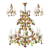 Lustrous chandelier with two wall lights decorated with foliage and pendants.