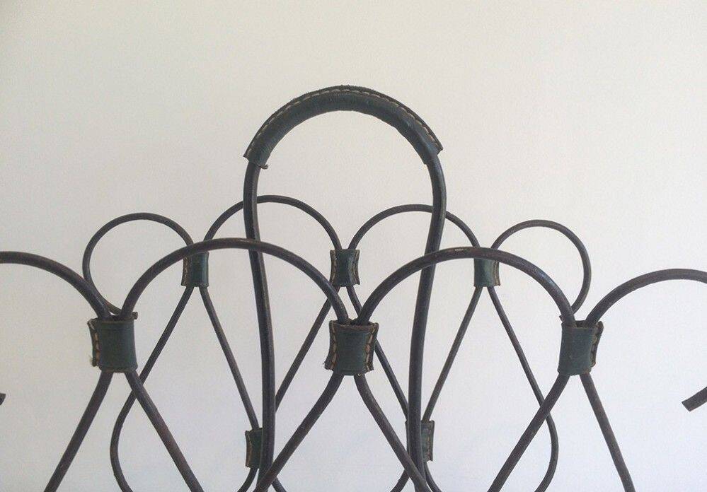 Magazine rack in leather and black lacquered metal. Attributed to Jacques Adnet