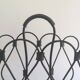 Magazine rack in leather and black lacquered metal. Attributed to Jacques Adnet