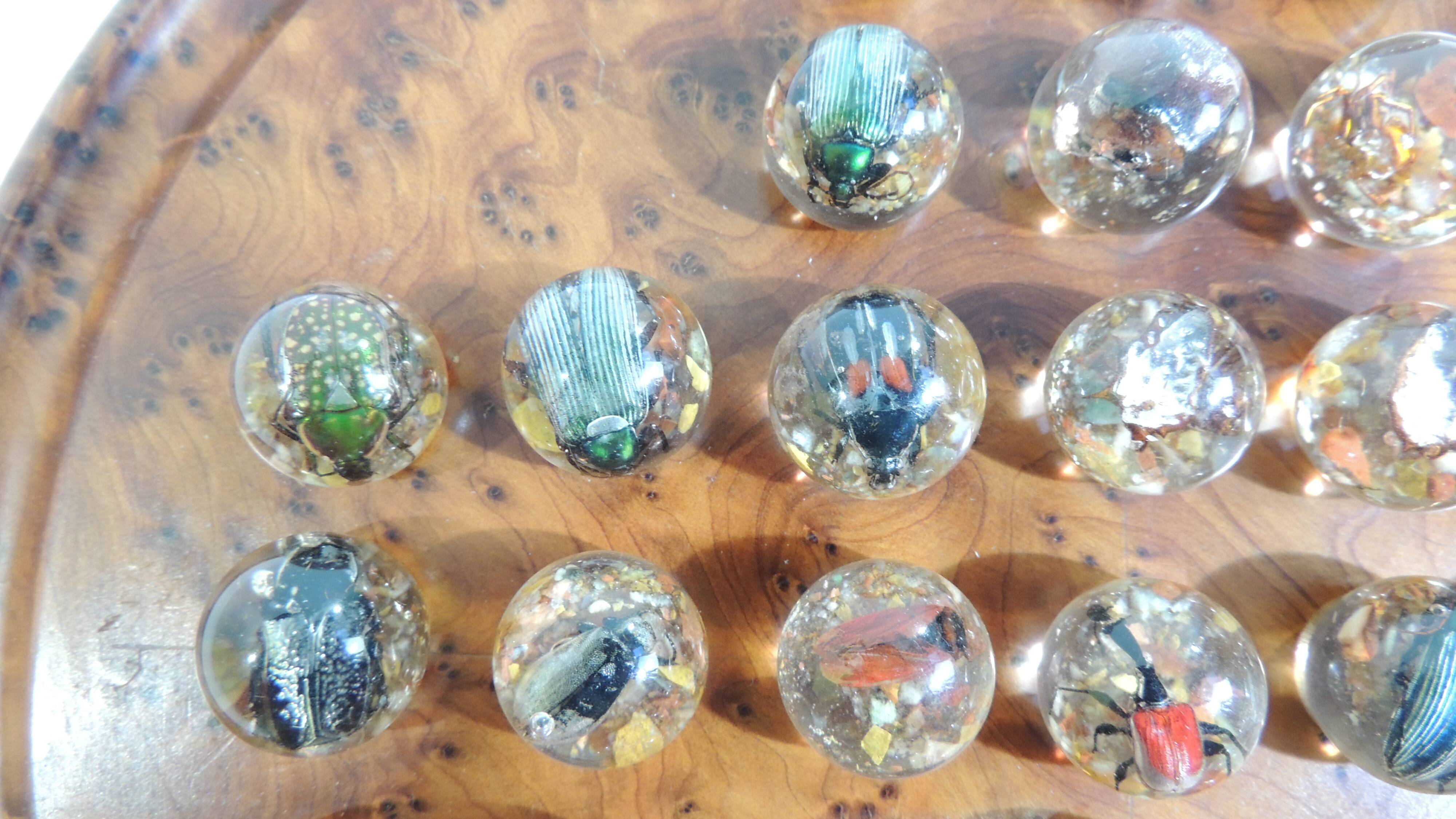 Vintage wooden solitaire game with resin balls and insects – Madaga