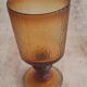 Set of four thick amber glass stemmed glasses.