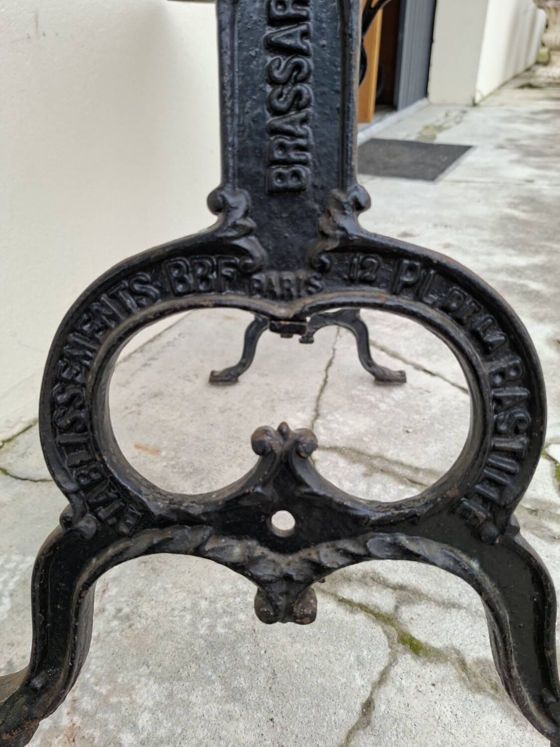 Solid oak bistro table with a cast iron base, signed.