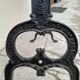 Solid oak bistro table with a cast iron base, signed.