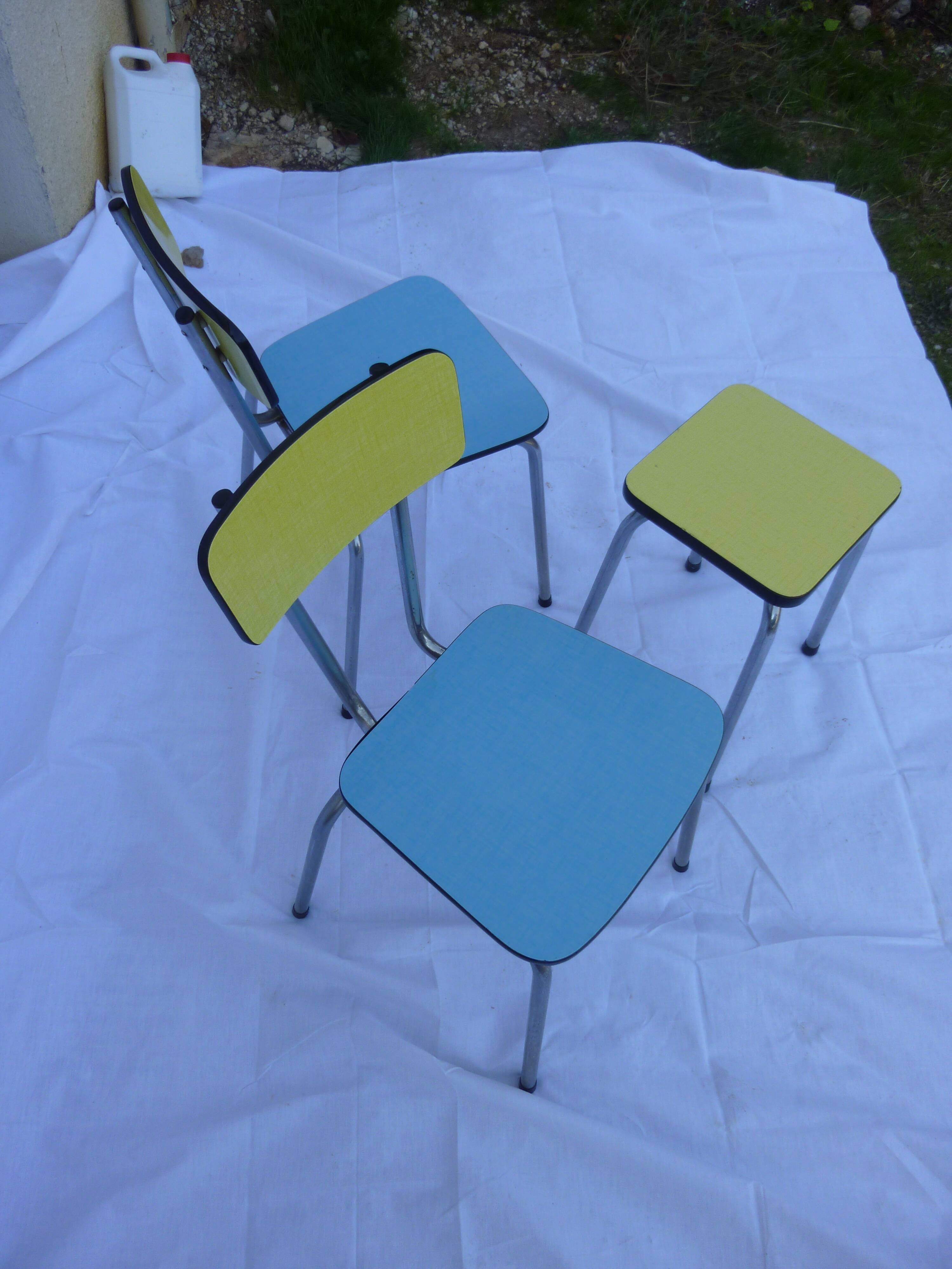 Two chairs and a yellow and blue stool in formica