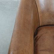 Characterful club chair made of sheepskin leather with light cognac colours