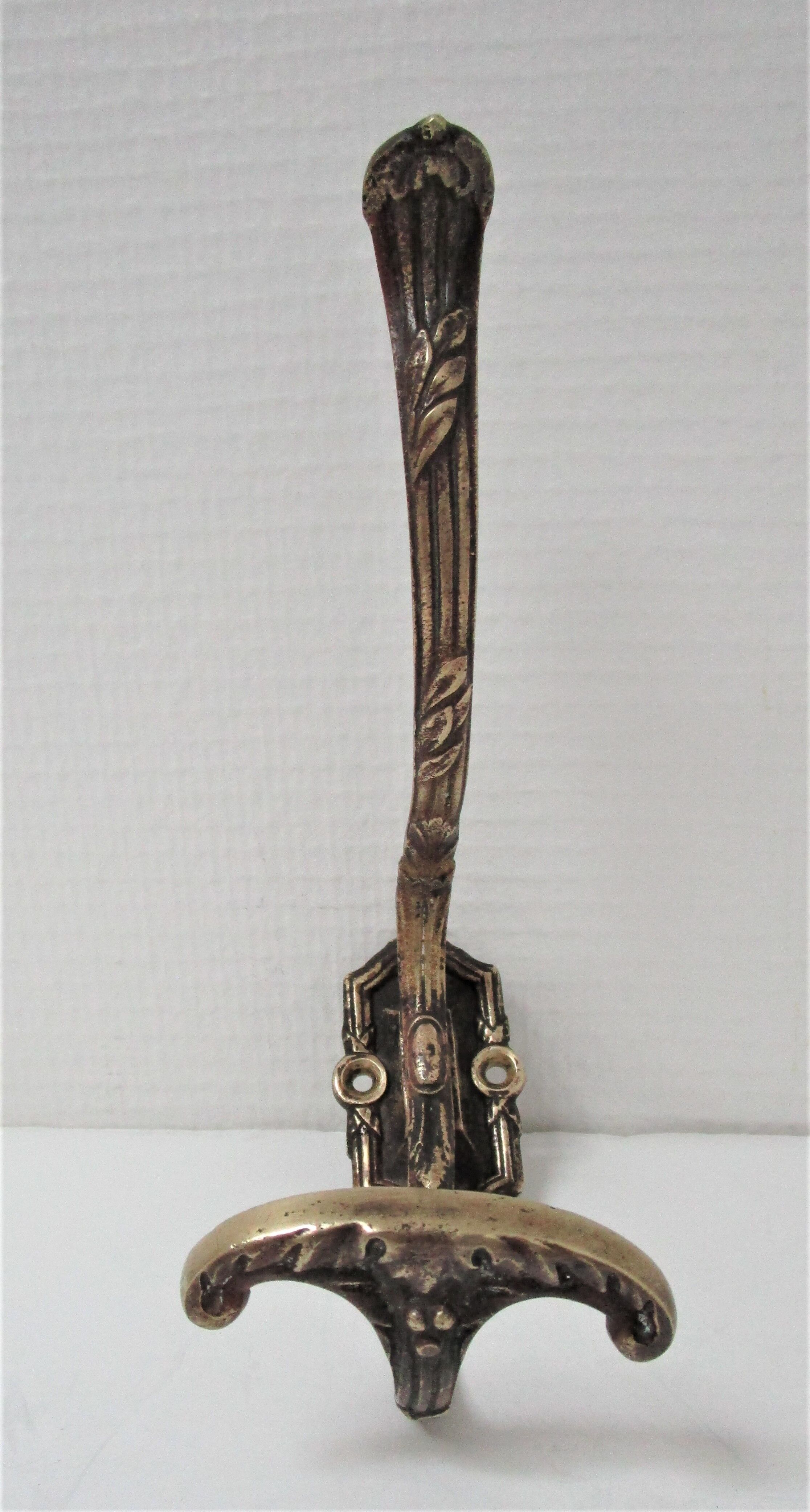 Four patères bronze patinated leafy décor early 20th century