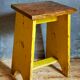 Art-populaire workshop stool in patinated wood
