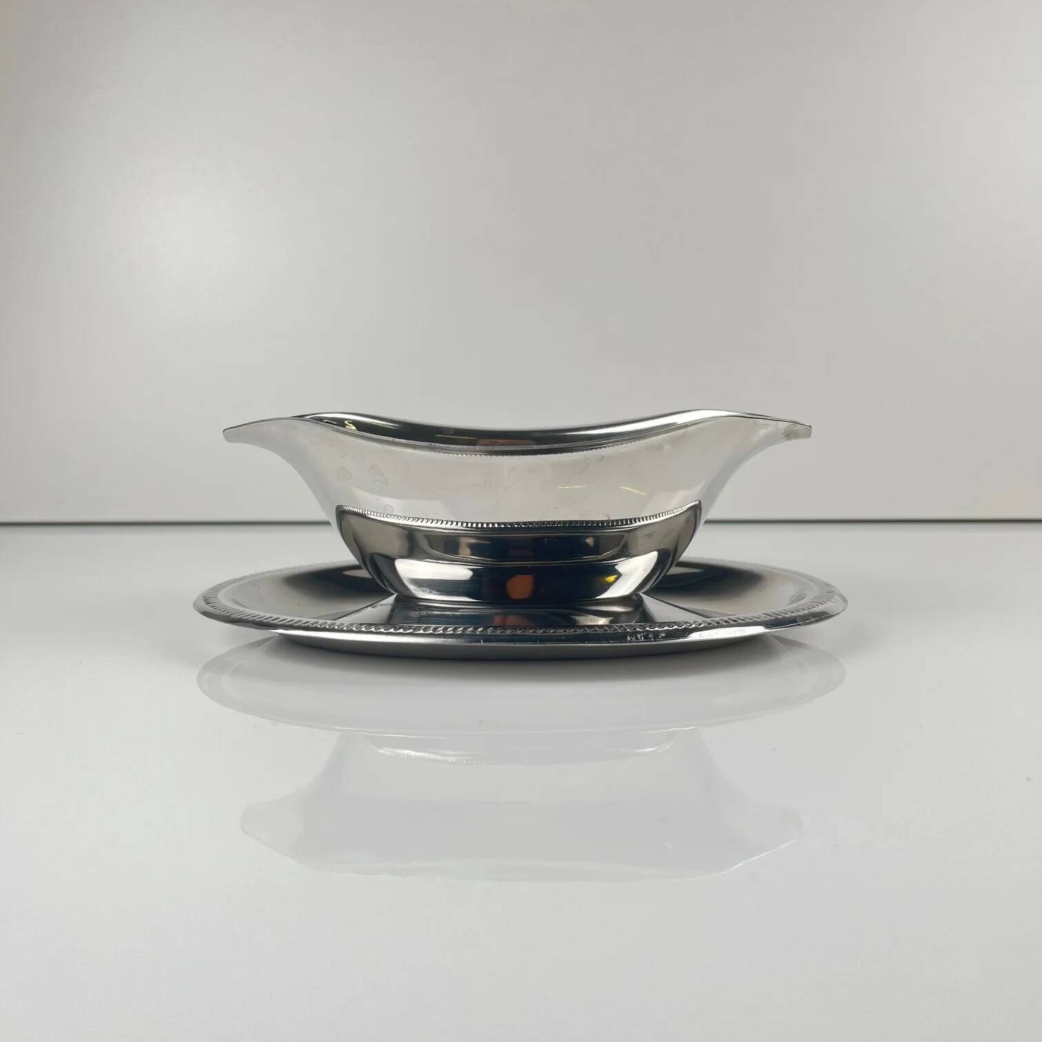 Metal sauceboat in Empire style, silver colour.