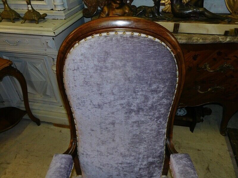 Relaxed Voltaire armchair with walnut racks