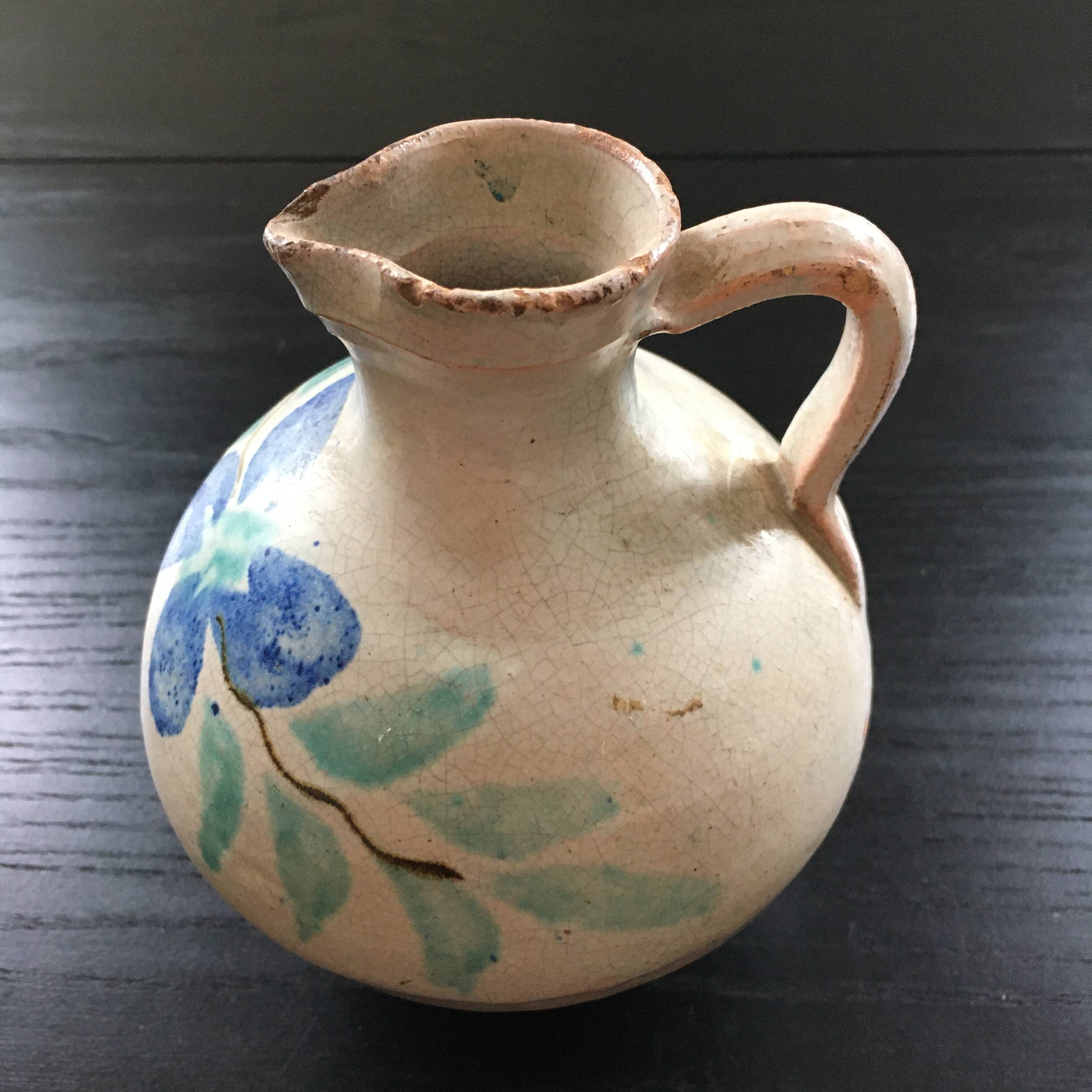 Antique pitcher with floral decoration
