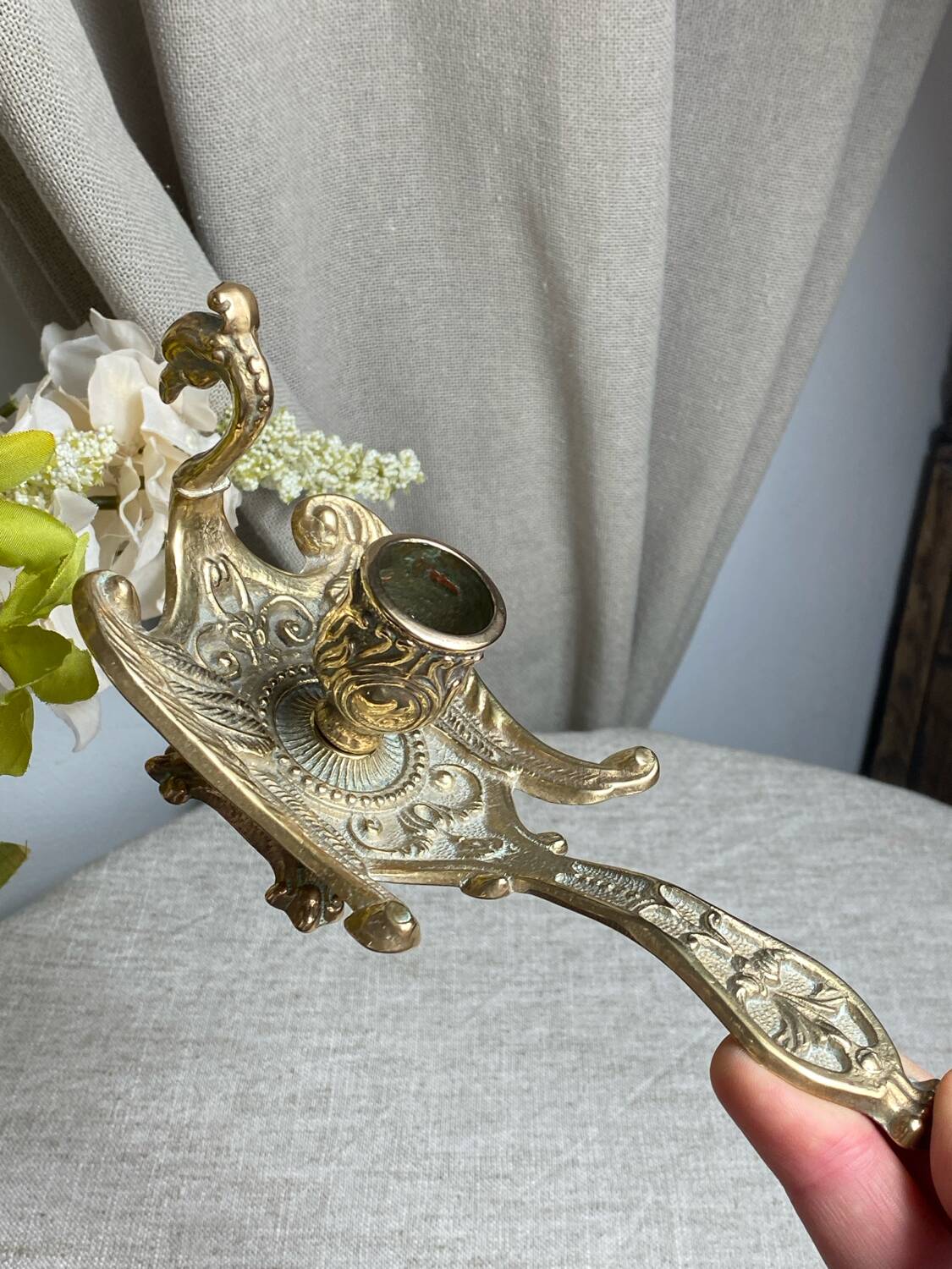 Bronze hand candlestick in the shape of a peacock