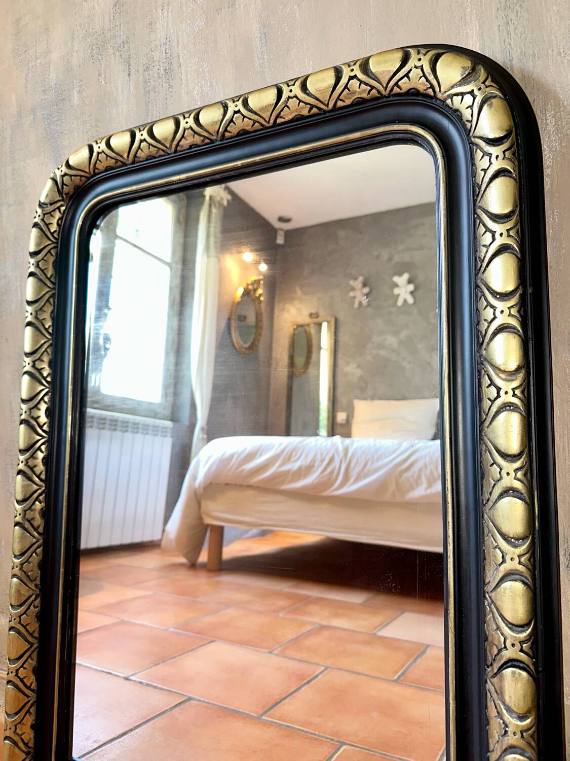 Louis-Philippe black and gold antique mirror from the 19th century