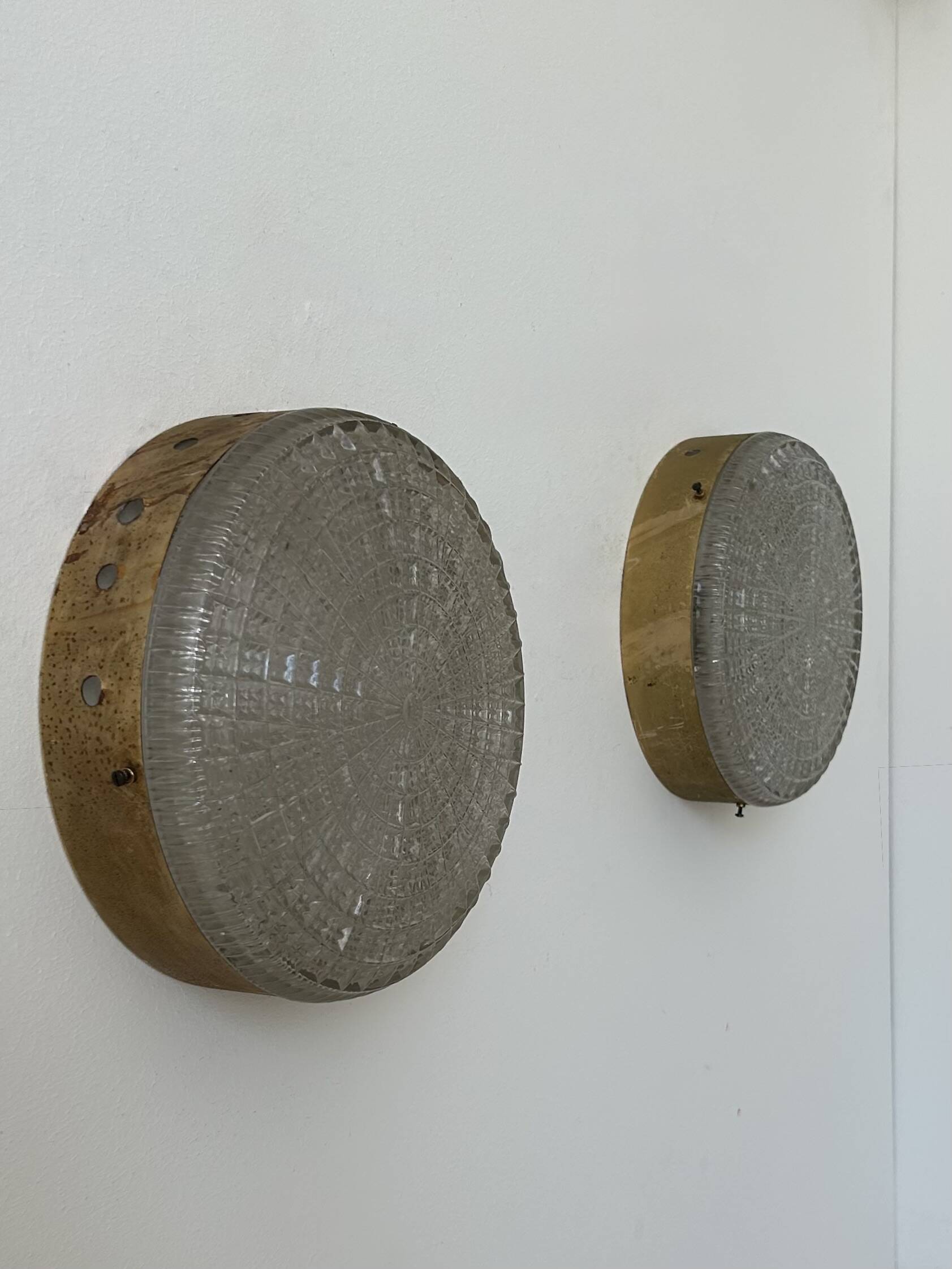 Pair of vintage wall lights in gilded metal and pressed moulded glass, France, 1970.