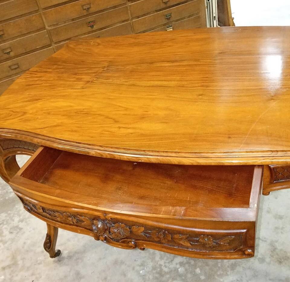 Curved desk in Louis XV style, made of carved and moulded walnut.