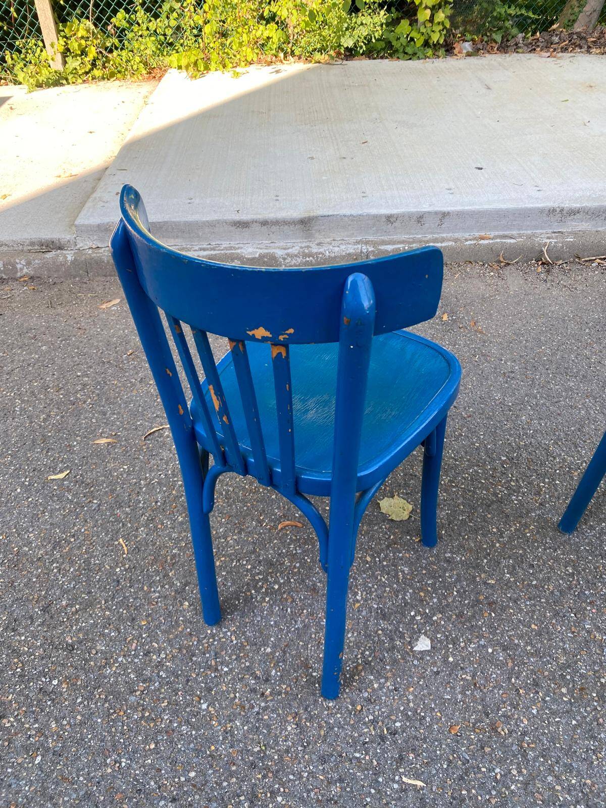2 blue bistro chairs in curved solid wood