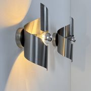 Pair of vintage wall lights, curved patinated steel, France, 1970.