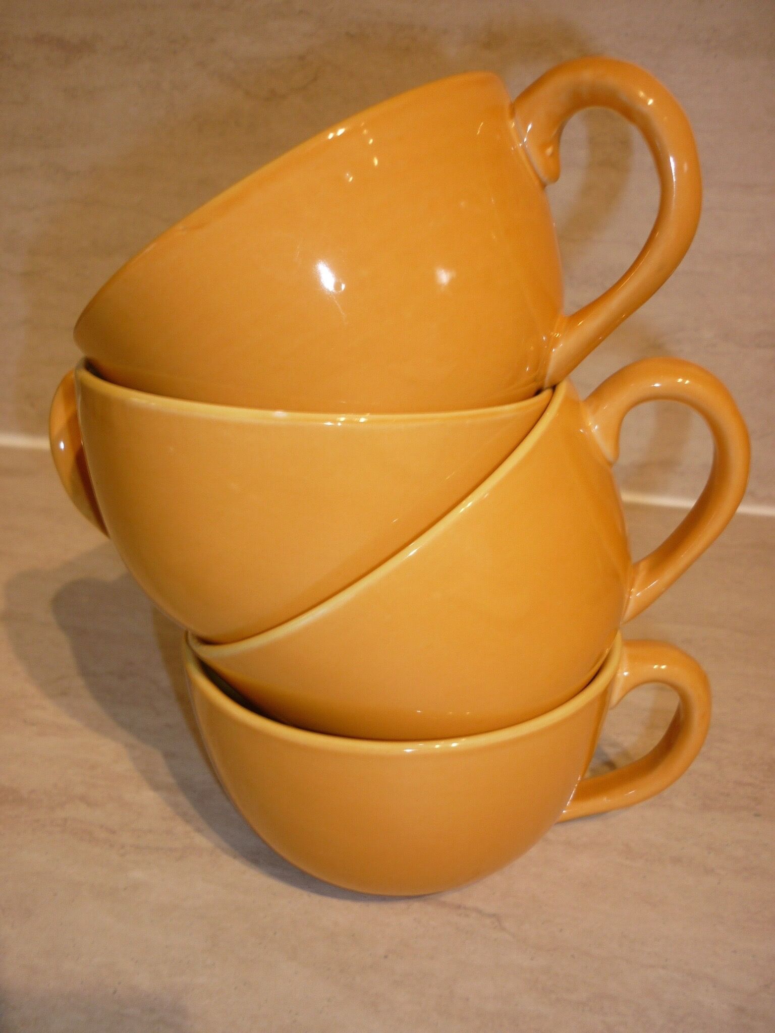 4 yellow and orange ceramic cups
