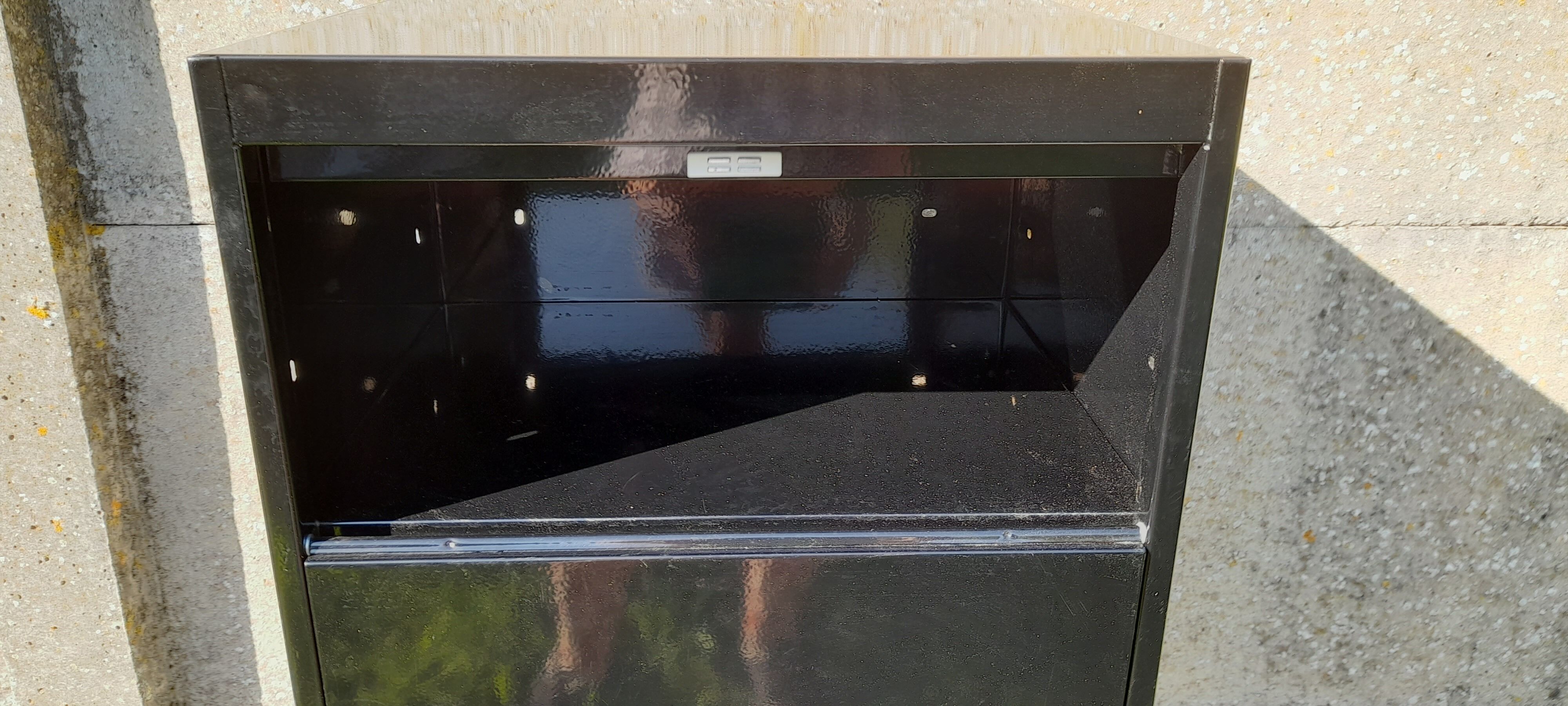 Black metal clamshell cabinet