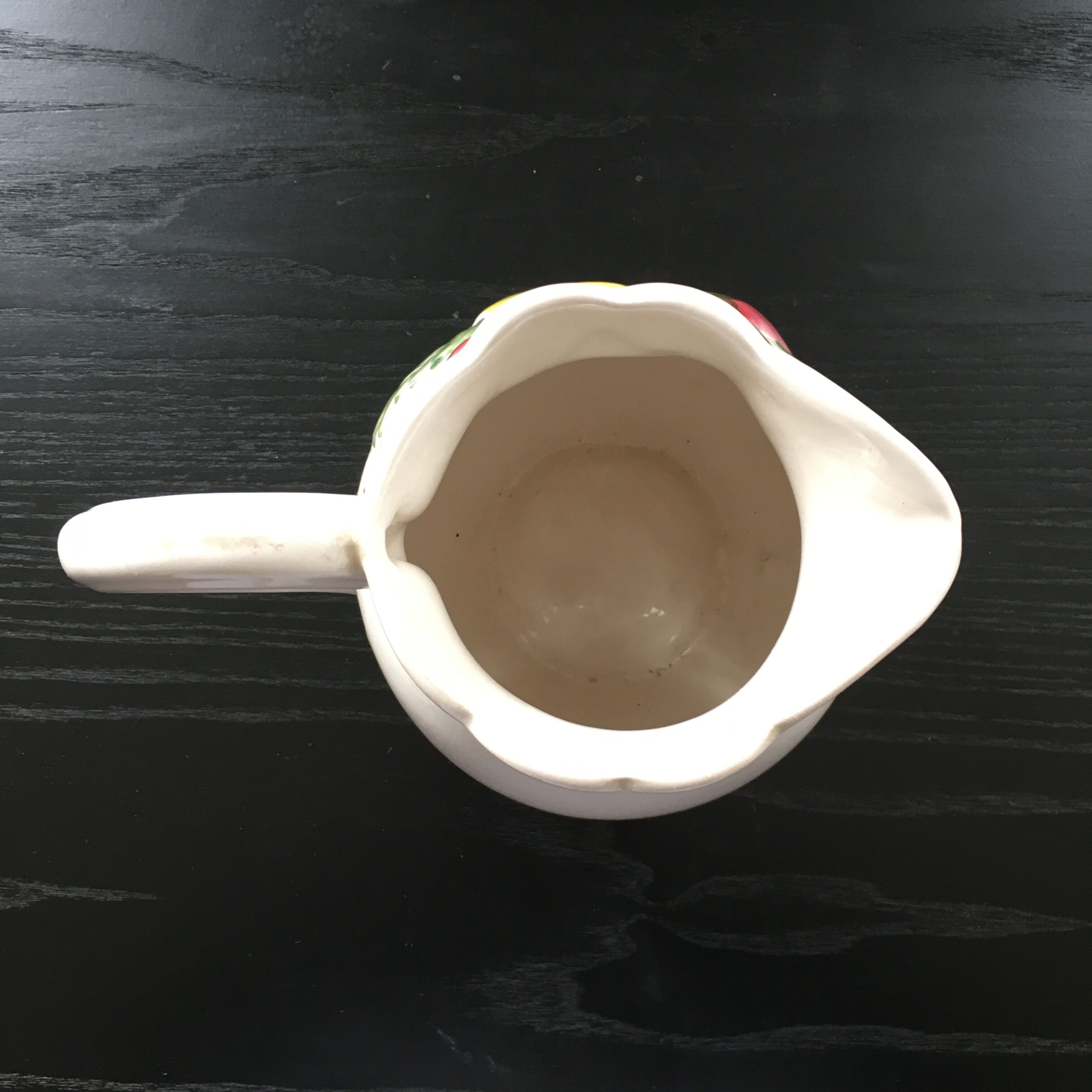 Fruit-decorated pitcher in slipware