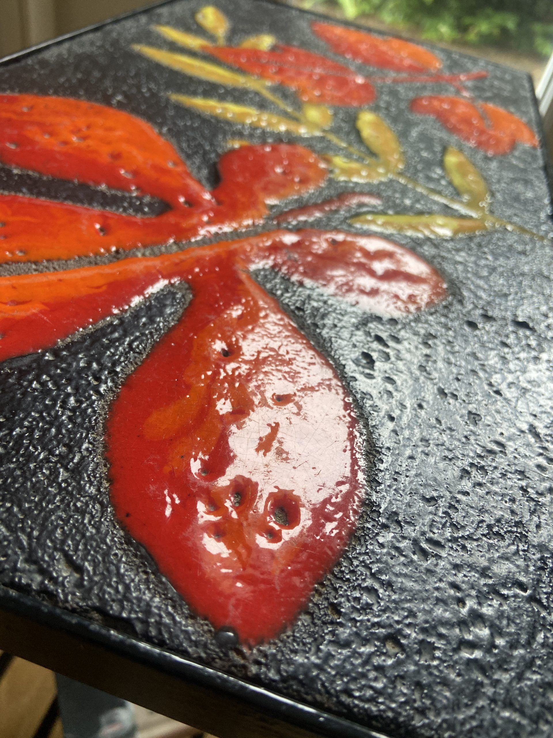 Side table or end of sofa in wrought iron and enamelled lava stone circa 1960