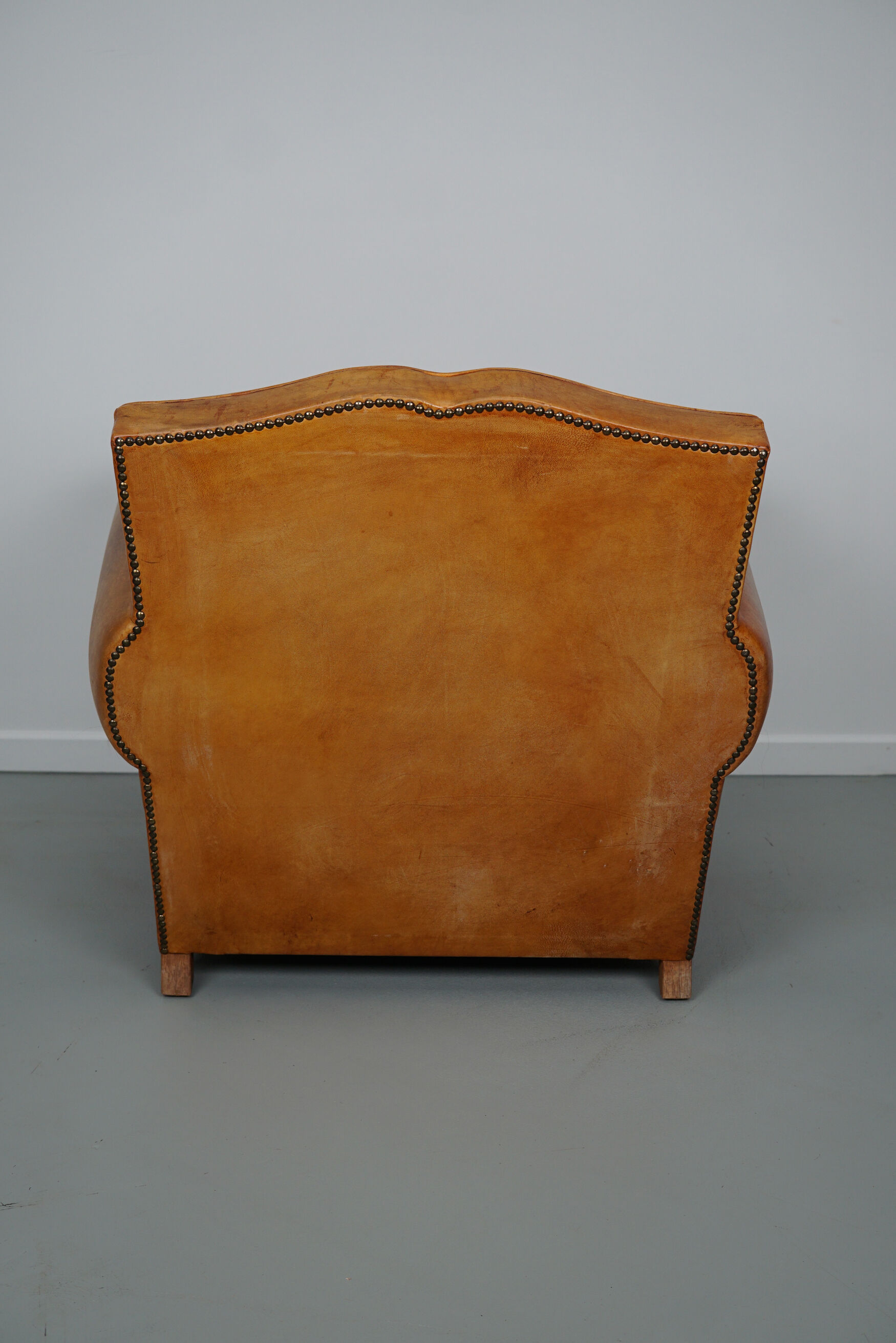 Vintage french moustache back cognac-colored leather club chair