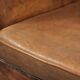Sheepskin club armchair in a brown colour finished with decorative nails