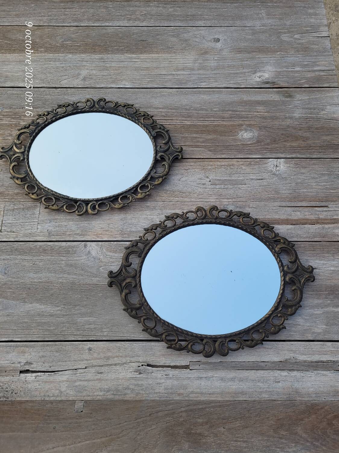 2 antique oval mirrors in heavy metal