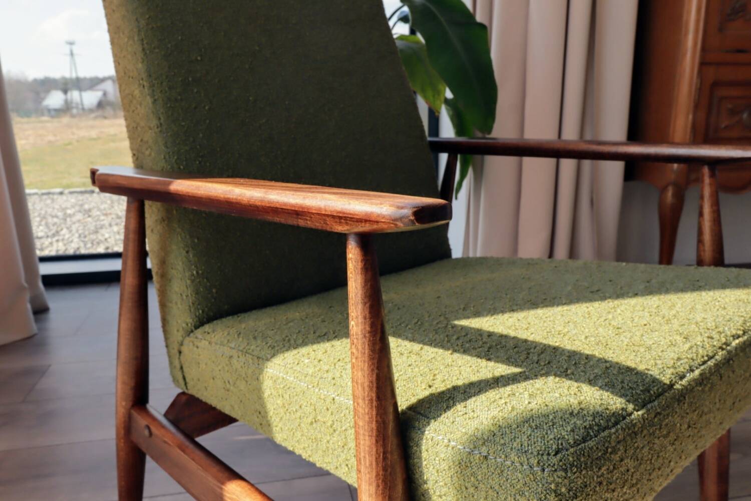 Mid-century modern armchair in olive green bouclé design by H. Lis.