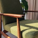 Mid-century modern armchair in olive green bouclé design by H. Lis.