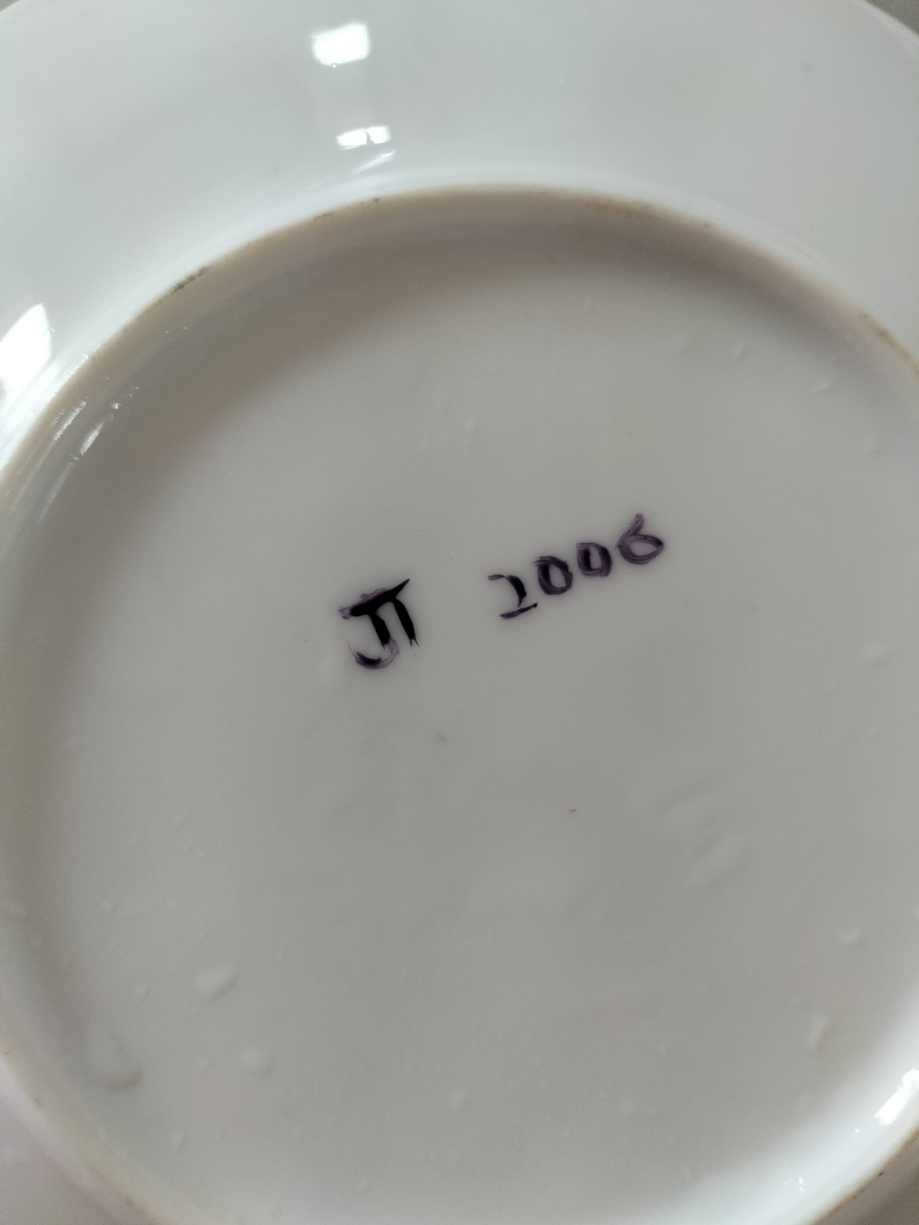 5 hand-painted dessert plates with stylised fruit designs.