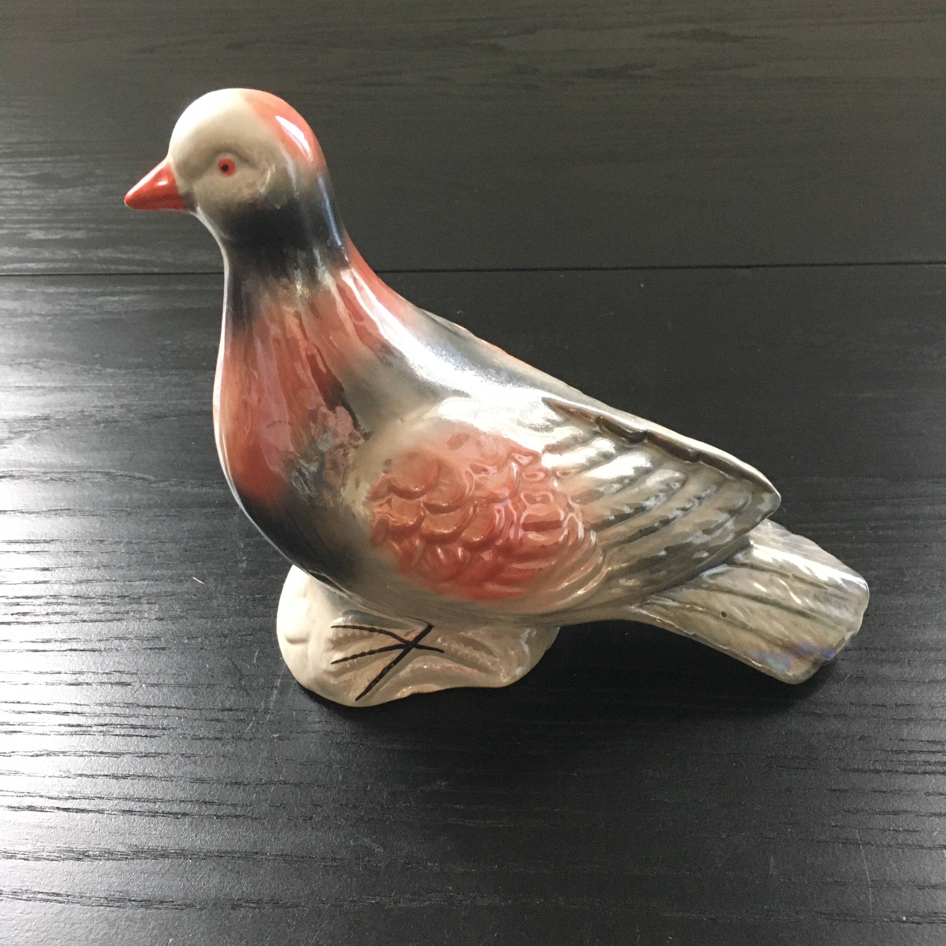 Antique bird in pearly ceramic