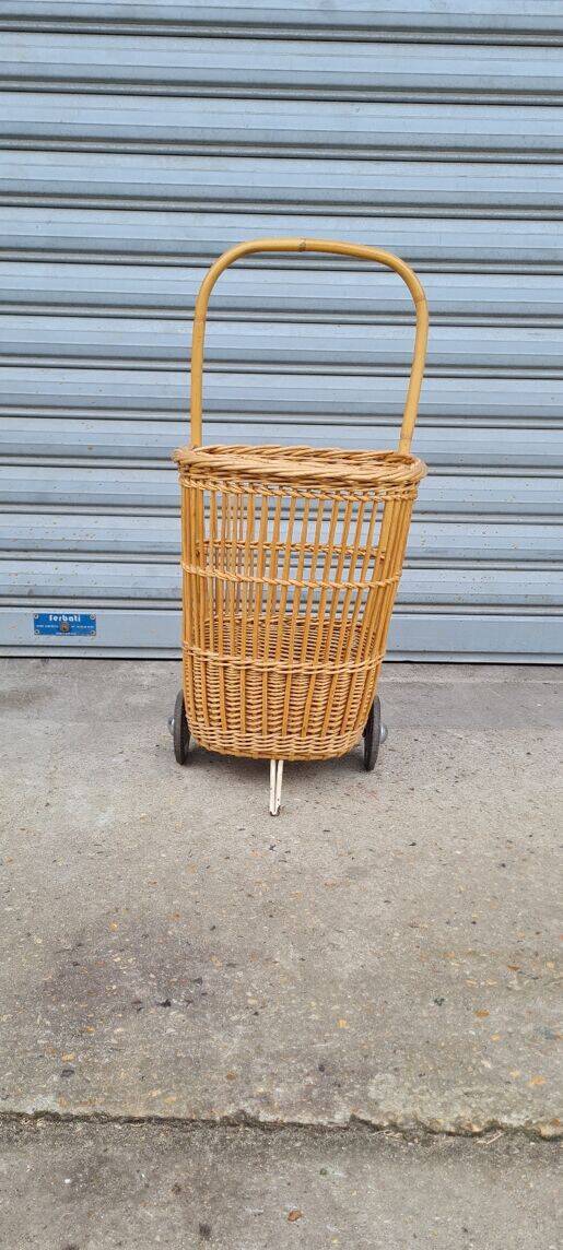 Vintage wicker log basket on vintage wheels