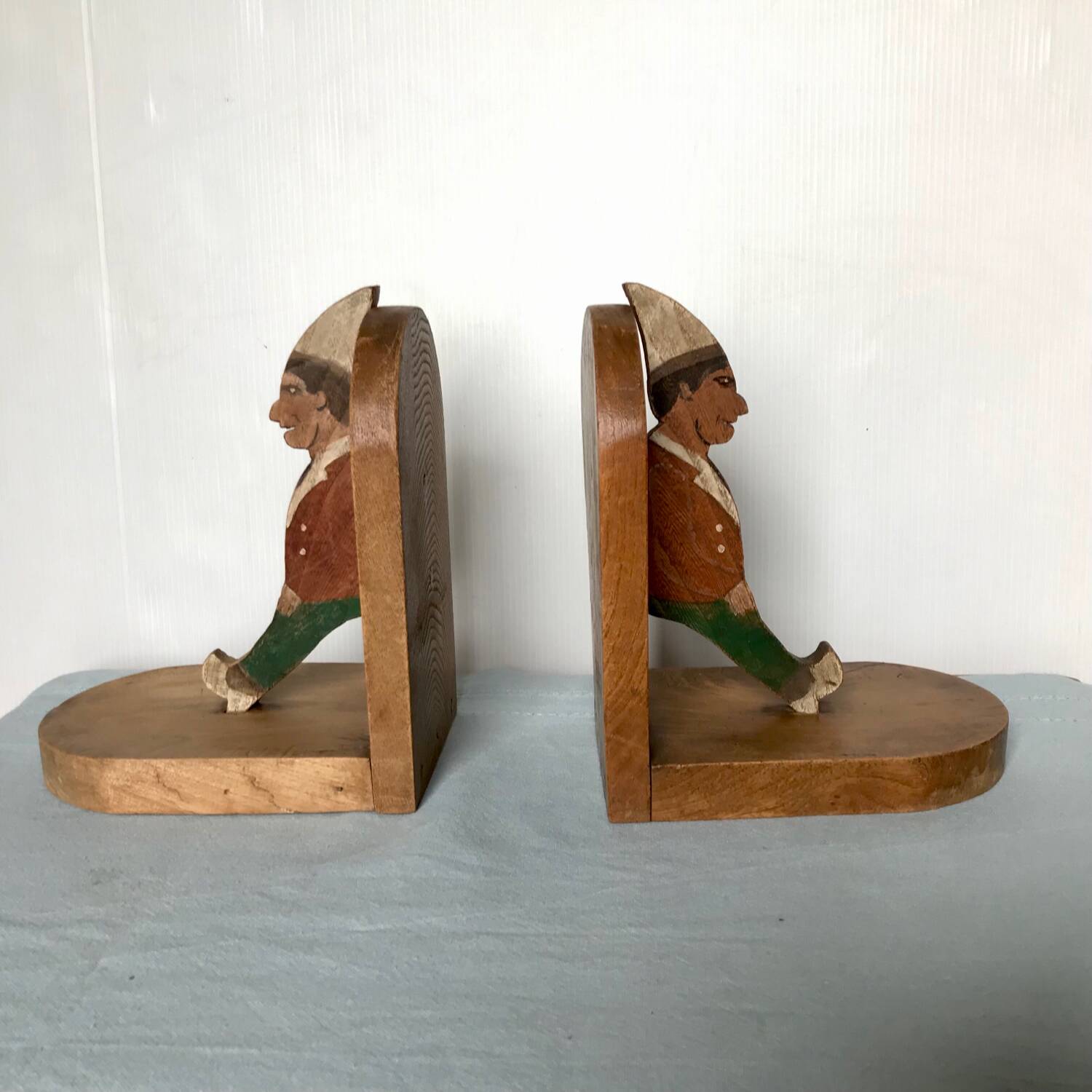 Old wooden bookends with painted characters