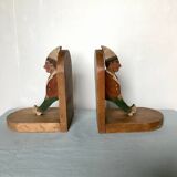 Old wooden bookends with painted characters