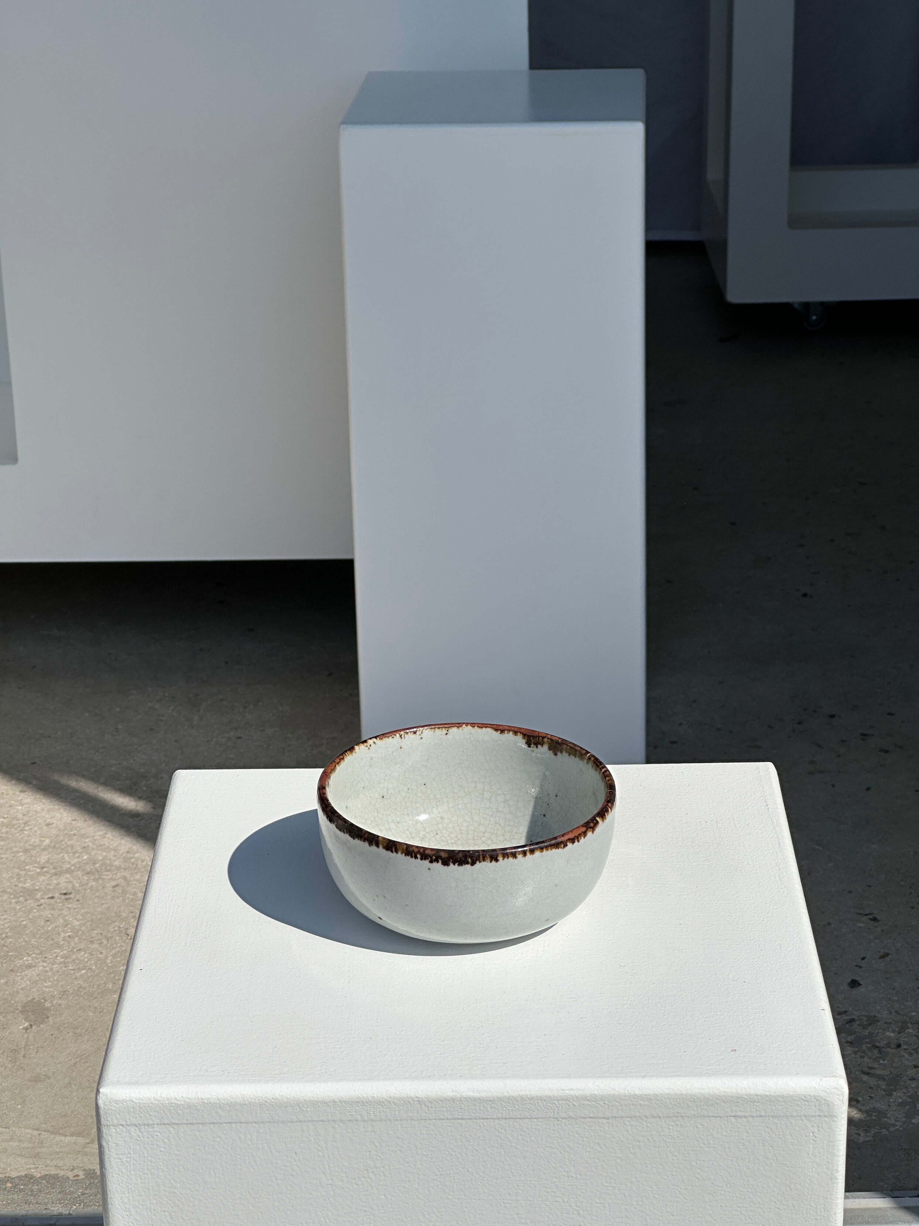 Small white glazed ceramic bowl black edges