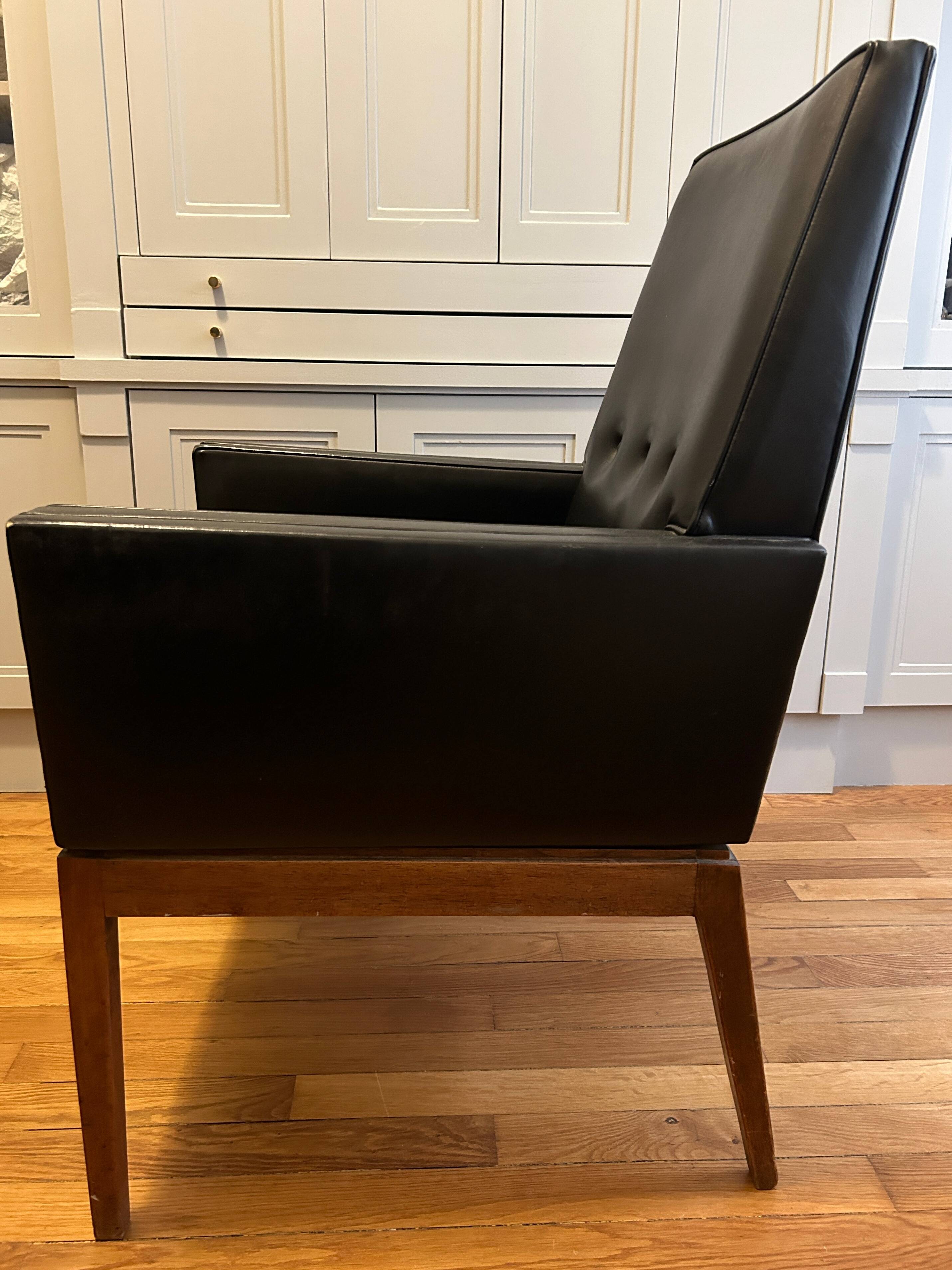 Modernist armchair in wood and black synthetic leather, circa 1960