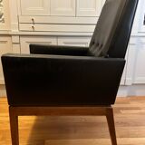 Modernist armchair in wood and black synthetic leather, circa 1960
