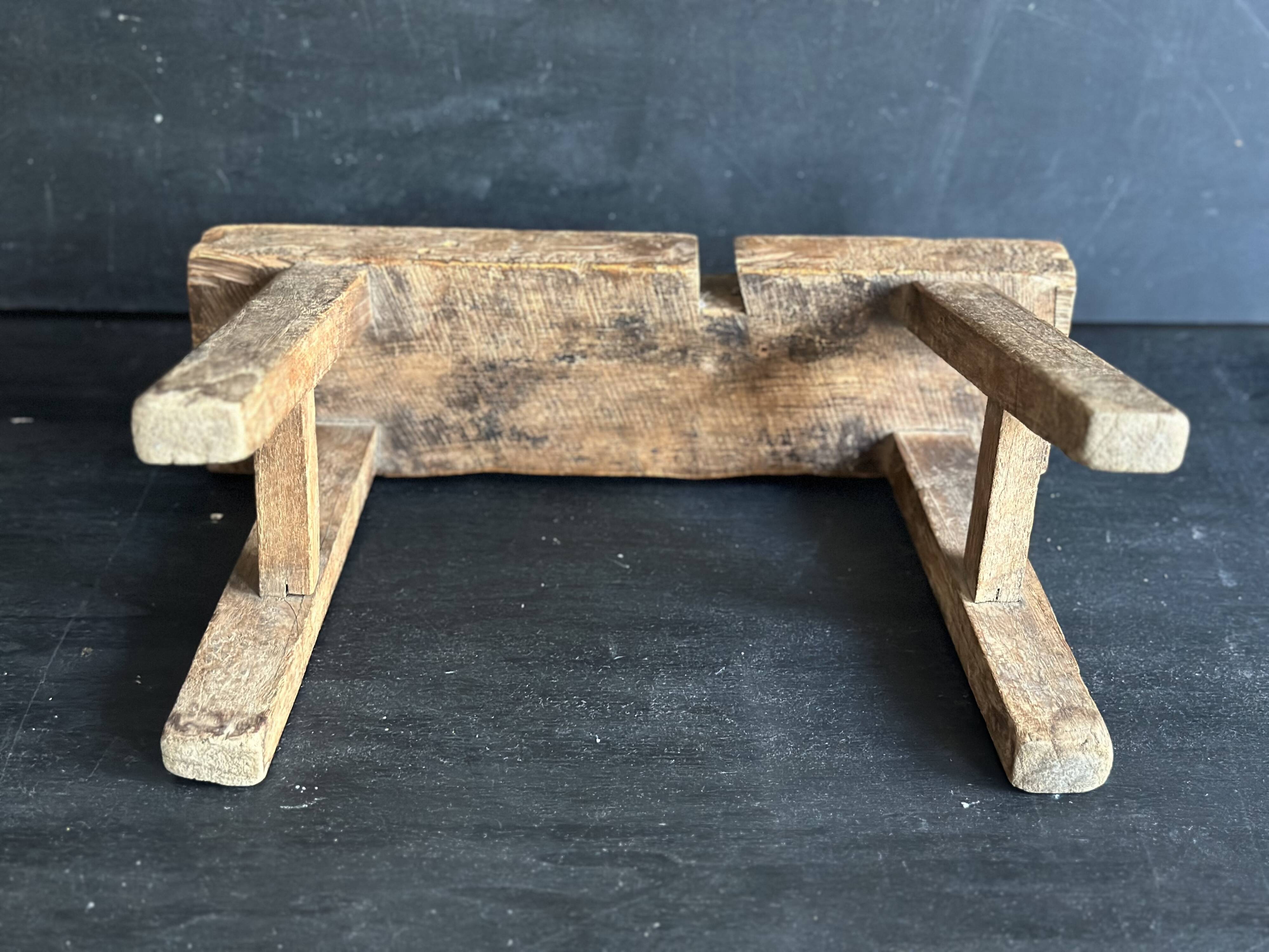 Ancient Chinese farm bench in patinated wood, small rustic stool.