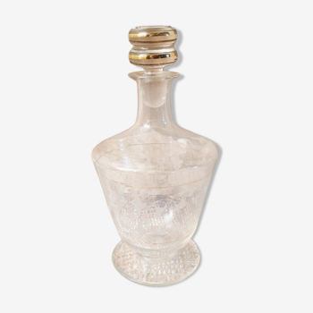 Glass liquor carafe. Stylized floral decorations and gold edging