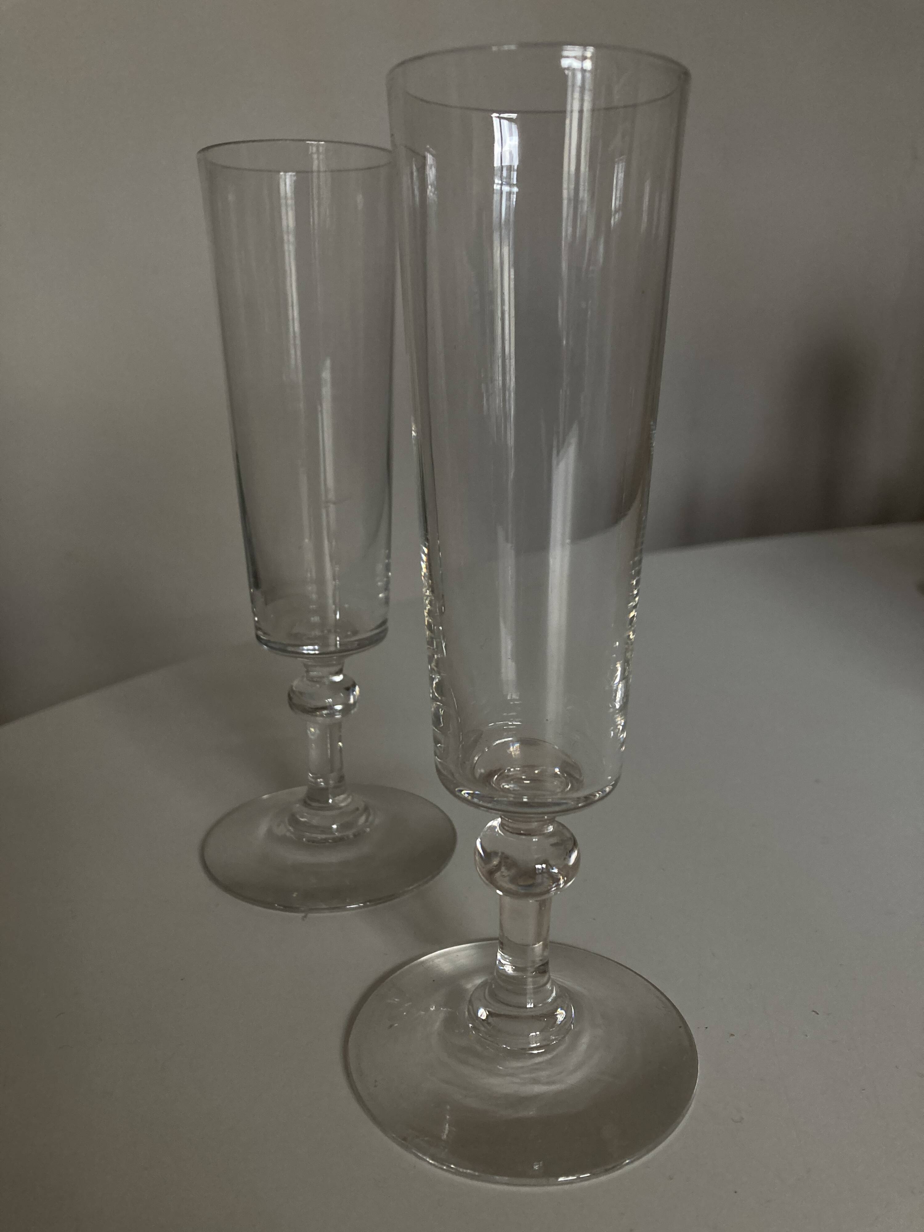 Pair of crystal champagne flutes with a button foot, 1960.