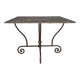 Table en fer forgé à piétement sculptural, ornée de volutes
