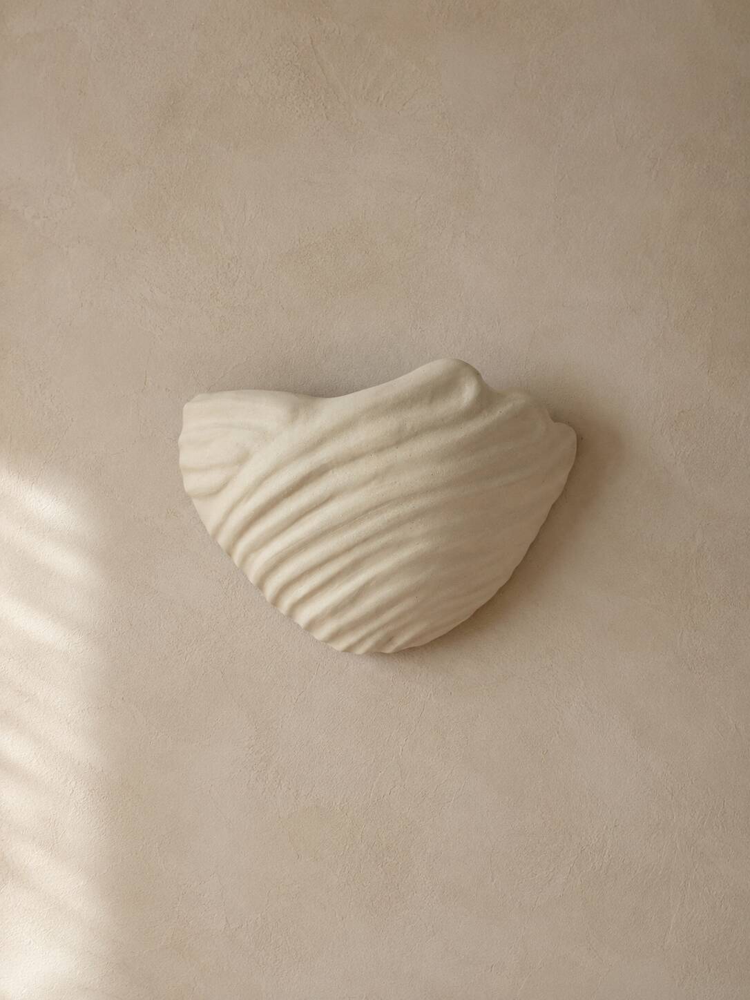 Shell-shaped ceramic applique handcrafted.