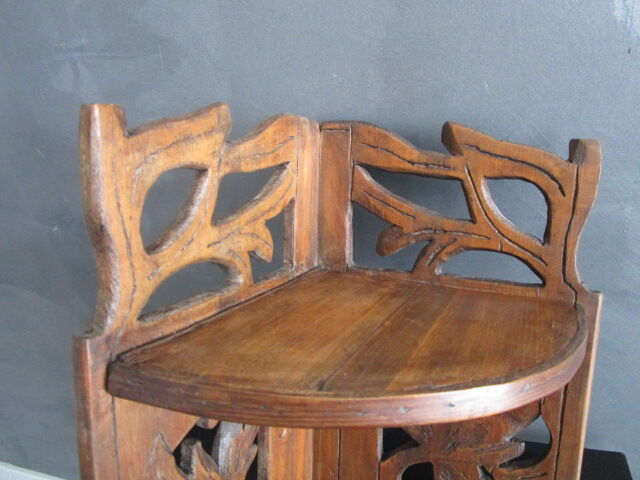 Old corner shelf in worked wood