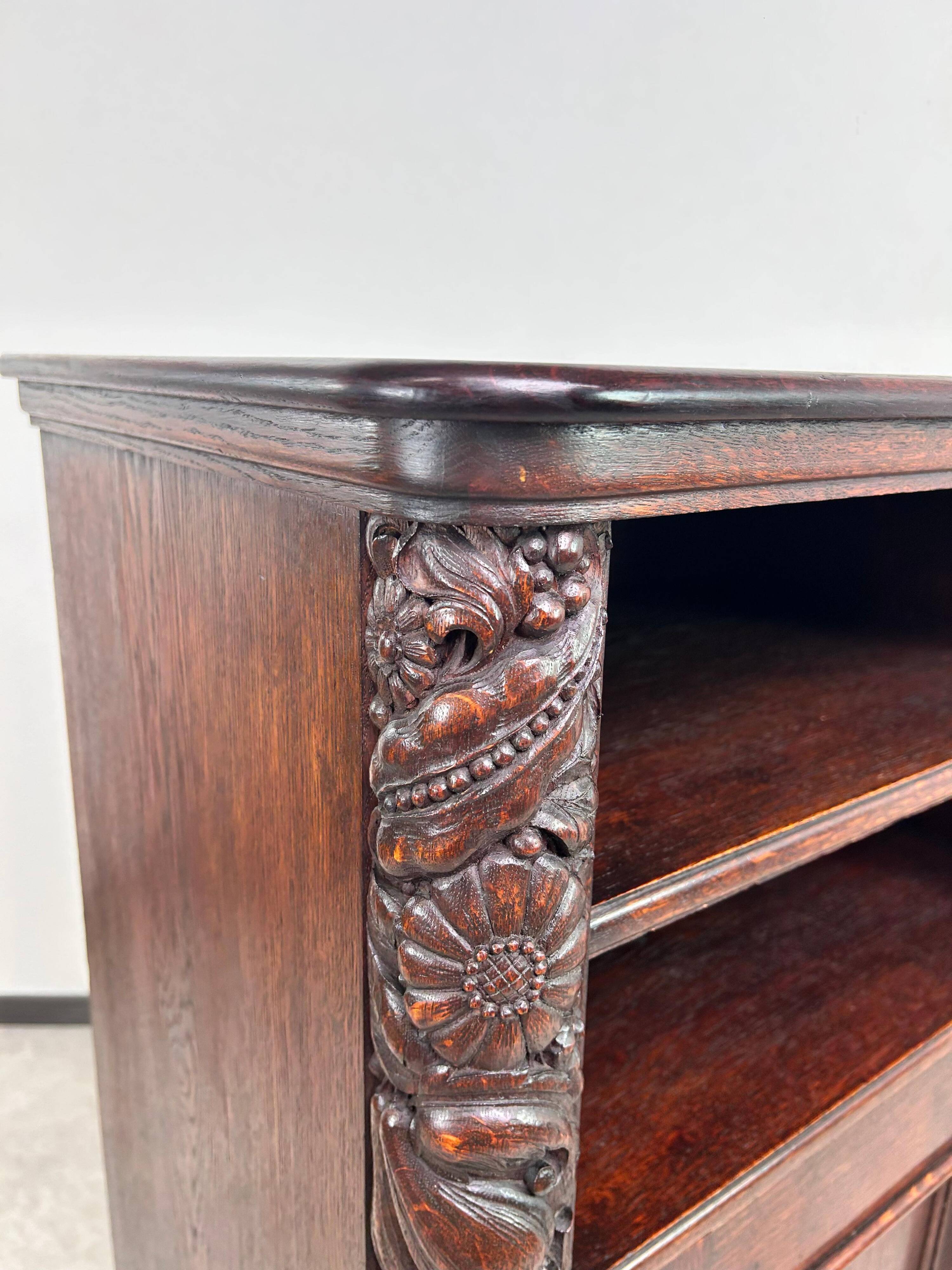 Art Nouveau cabinet with a shelf featuring distinctive floral sculptures.