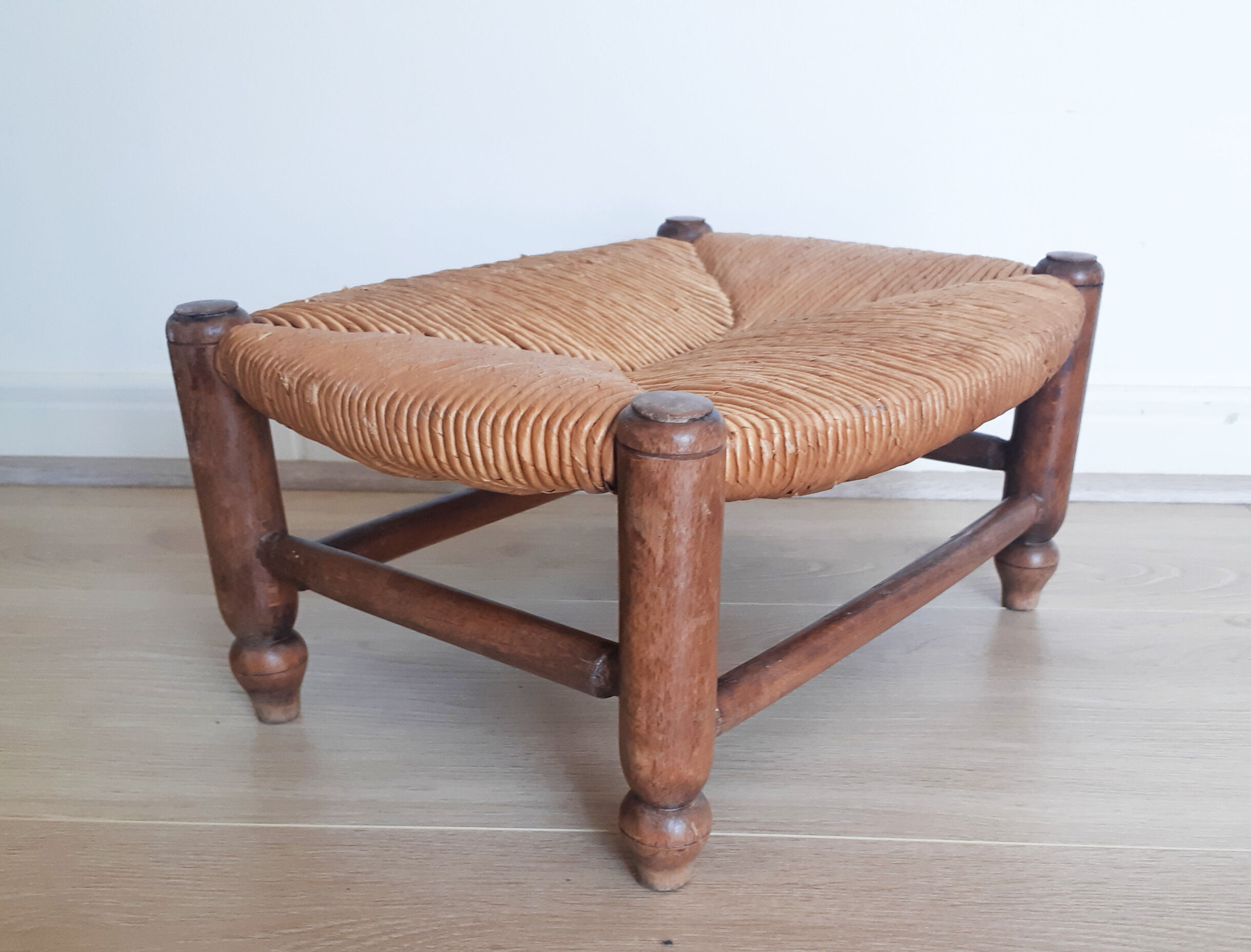 Low wooden stool and straw