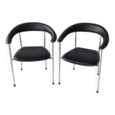 Set of two metal chairs with a brushed finish and black leather.