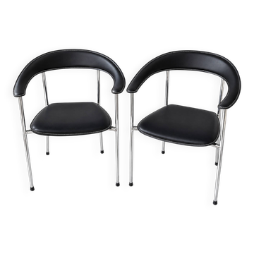 Set of two metal chairs with a brushed finish and black leather.